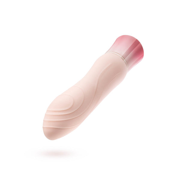 The Oh My Gem Morganite Warming Beginner Mini Vibrator by Blush is a pink, cylindrical vibe featuring a smooth, contoured design with a slightly curved tip. Its base has a slightly darker pink accent. Equipped with vibrating functions and waterproof capability, this device is ideal for versatile use. The product is displayed against a plain white background.