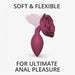 A promotional image featuring the Open Roses Medium Red Silicone Flower Butt Plug by Lovely Planet, with the text "SOFT & FLEXIBLE" at the top and "FOR ULTIMATE ANAL PLEASURE" at the bottom. The toy's ergonomic design and flared floral base emphasize comfort and aesthetic appeal.