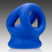 Presenting the Oxballs Tri Squeeze Cocksling Ball Stretcher in Blue, a silicone creation that combines smooth curves with interlocking loops. This innovative design from Oxballs, reminiscent of a body-safe silicone accessory, features rounded and hollow elements for an artistic and modern appearance against a captivating gradient background transitioning from dark gray to light gray.