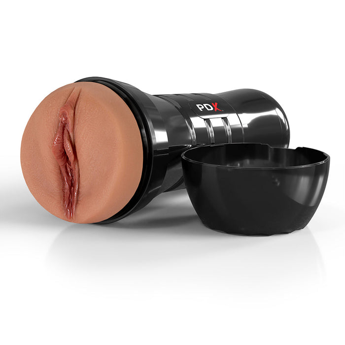 The PDX Juicy Snatch XXL Stroker for Large Penises in Chocolate is a black cylindrical toy featuring a realistic skin-tone front, precision suction control, and a side cap. It's made from self-lubricating TPE material and set against a white background.