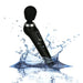 The Palm Power Extreme Rumbly Ergonomic Wand Vibrator by BMS Enterprises, a black handheld massager crafted from medical grade silicone, features a rounded head and a control panel with plus and minus buttons. It is depicted mid-air with splashes of water around it, highlighting its waterproof feature against a clean, light backdrop.