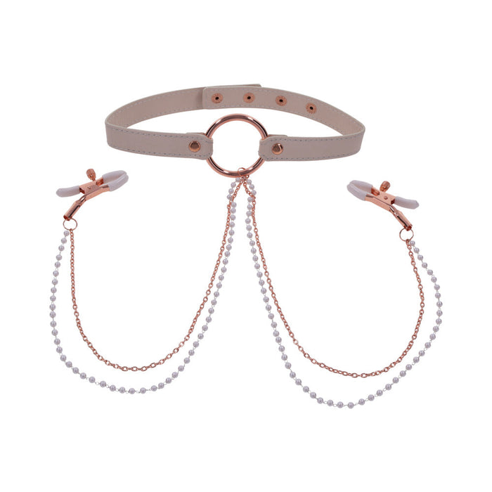 The Peaches 'n Cream Collar and Nipple Clamps by Sportsheets features a beige leather choker with rose gold hardware, showcasing a central metal ring linked to adjustable nipple clamps via chains decorated with small pearls. The clamps include plastic tips for added comfort.