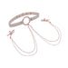 The Peaches 'n Cream Collar and Nipple Clamps by Sportsheets showcase a white adjustable collar with rose gold hardware, featuring a central ring that connects to rose gold nipple clamps via delicate chains. The clamps are finished with white tips, and the chains are embellished with small beads for an elegant touch.