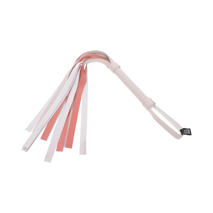 The Sportsheets Peaches 'n Cream Flogger displays a striking combination of pink and white faux leather, comprising multiple flat tails and a loop handle, all set against a pristine white background.