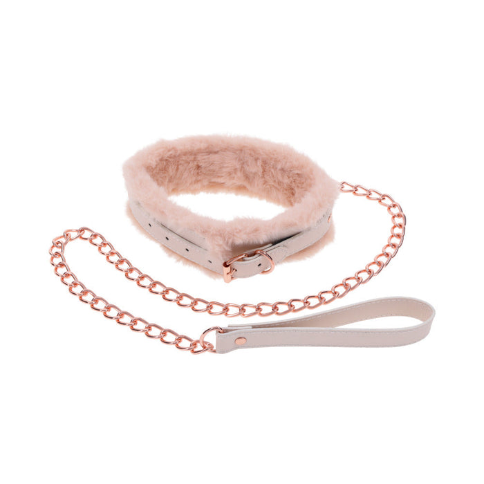 The Peaches 'n Cream Fur Collar and Leash by Sportsheets features a plush pink collar with a soft interior, accented by a rose gold chain link leash. This set is ideal for intimate moments, complete with a white looped handle on the leash and a buckle fastening on the collar.