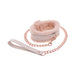 The Peaches 'n Cream Fur Collar and Leash by Sportsheets features a pair of pink faux fur-lined wrist cuffs connected by a rose gold chain with a matching leather strap, ideal for crafting intimate moments and exploring gentle bondage.