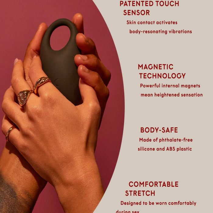 A hand holding a Pepper Connect Vibrating Cock Ring designed with touch sensor, magnetic technology, and body-safe silicone, highlighting the features for comfort and enhanced sensation.