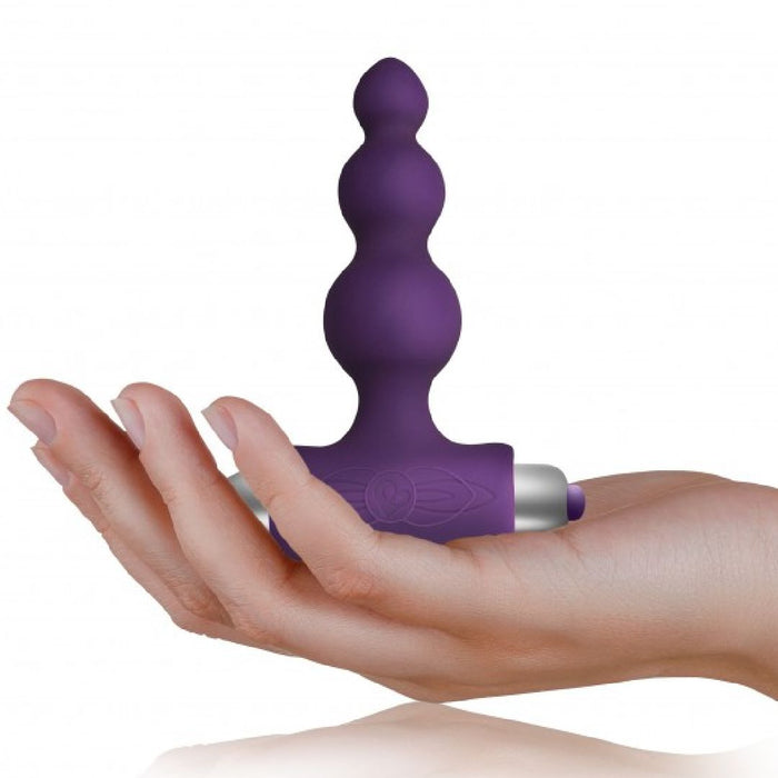 Petite Sensations Bubbles Butt Plug - Purple held in a hand