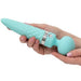 Two hands hold the Pillow Talk Sultry Warming Double Ended Wand Vibrator - Teal by BMS Enterprises, featuring a pointed, ribbed tip and a round base. This double-ended vibrator boasts a diamond-pattern texture on its shaft and has a metallic ring near the base. Crafted from premium silicone, it is both stylish and functional. The person's fingernails are painted light pink.