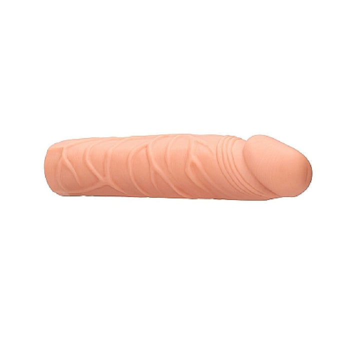 A Realrock 7 Inch Penis Extender Sleeve - Vanilla by Shots, designed to resemble a penis, featuring lifelike veins and detailed textures. Made from body safe materials, it is positioned horizontally on a plain white background.