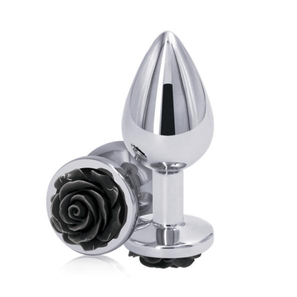 The Rear Assets Black Rose Metal Anal Plug - Small by NS Novelties features a sleek, reflective surface with a black rose design on the base. This rose chrome-plated anal plug is perfect for temperature play and comfortable long-term wear.