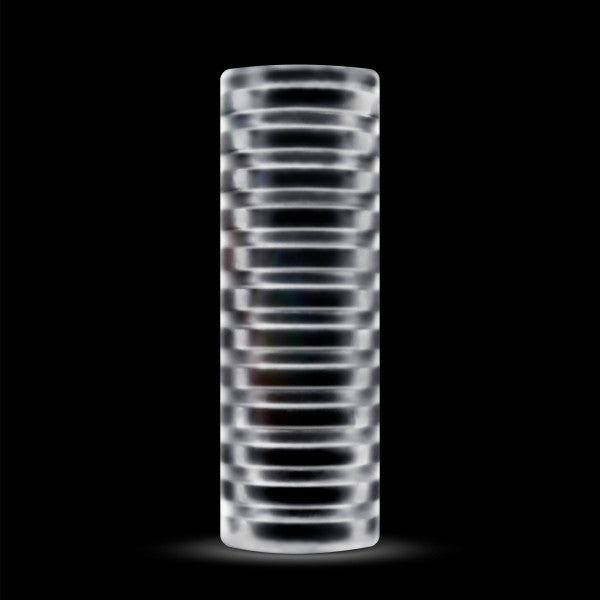 The Rize Ribz Self Lubricating Glow in the Reversible Dark Stroker by Blush stands vertically against a black background. This translucent cylindrical object features evenly spaced horizontal ridges or rings throughout its length, creating a ribbed texture that enhances the light reflection.