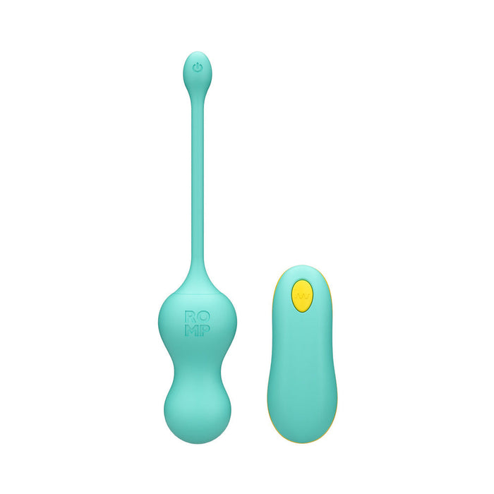 The image displays the Romp Cello Remote Control Vibrating Egg in a turquoise color, made from premium silicone, and equipped with a long, slender pull cord. Accompanying it is a matching remote control featuring a single yellow button. The vibrating egg, embossed with the word "ROMP," offers 10 versatile vibration functions for enhanced pleasure. This product is brought to you by the brand WOW.