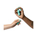 Two hands holding a turquoise Romp Cello Remote Control Vibrating Egg from WOW, made of premium silicone. The right hand, which has a cube tattoo on the wrist, is holding the vibrator, while the left hand holds the wireless remote. The background is white.