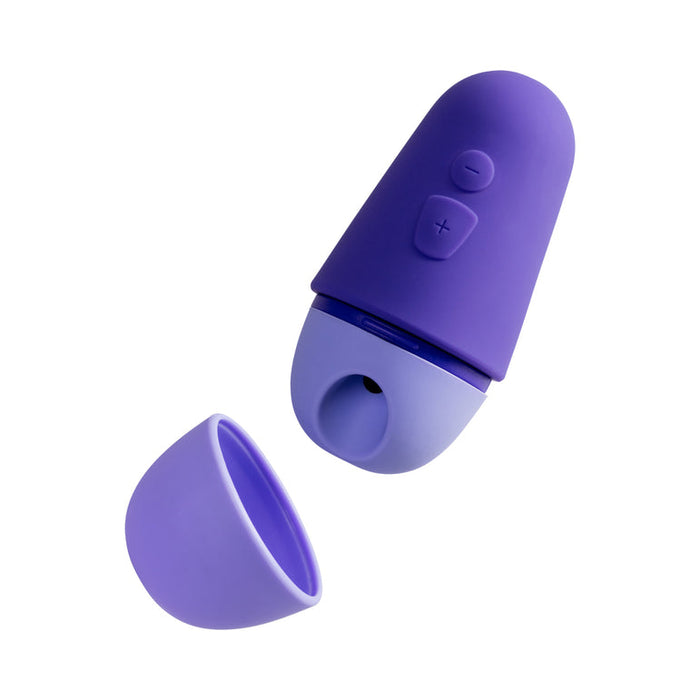 The WOW Romp Free X Beginner's Pleasure Air Clitoral Stimulator with Lid is depicted here in its vibrant purple, silicone-covered form without the lid. It boasts a rounded tip and user-friendly buttons to adjust power and intensity, delivering optimal pleasure through its rechargeable design. The lid, displayed adjacent to the stimulator, fits securely for added travel convenience.