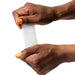 Romp Mosh Compact Reversible Manual Stroker - Clear being stretched by hand model on a white background