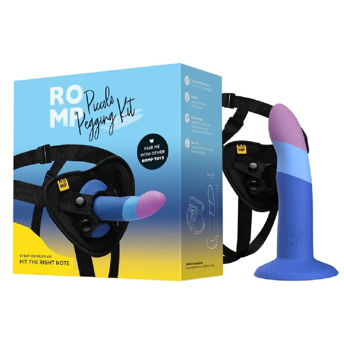 Product image of the Lovehoney Romp Piccolo First Time Pegging Kit, showing a blue and purple Piccolo dildo attached to a black harness, alongside the product packaging.