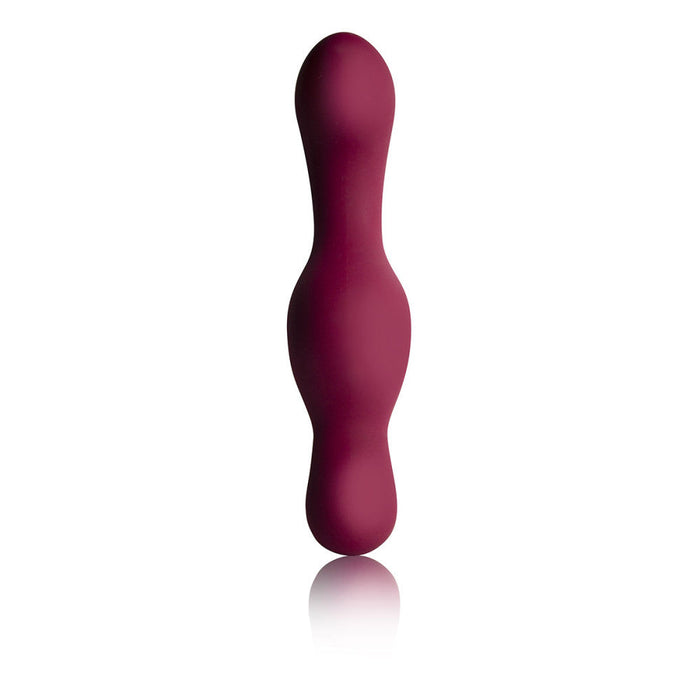 Introducing the Ruby Glow Blush External Grinding and G-Spot Vibrator with Remote by Rocks Off: a maroon, silicone, double-ended massage tool featuring a bulbous shape with one end larger than the other. This smooth, seamless vibrator is meticulously designed for ergonomic handling and precise G-spot stimulation. Standing upright against a white background, it is ready to deliver unparalleled satisfaction.