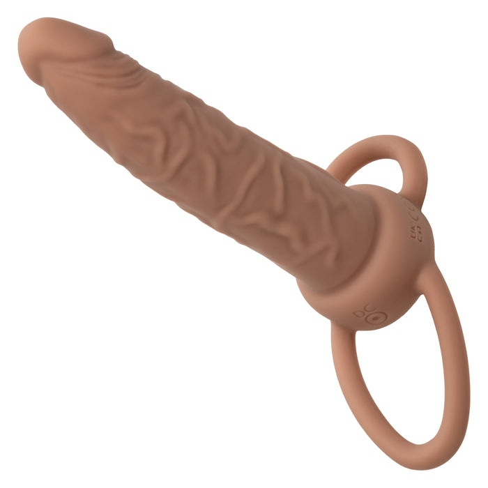 The Performance Maxx Double Penetration Vibrating Dildo in Light Chocolate is a silicone strap-on designed for double penetration with realistic detailing, ideal for personal use.