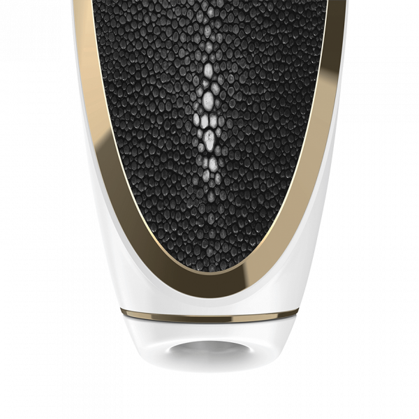 A close-up of the Satisfyer Luxury Air Pulsation + Vibration showcases its premium design, featuring a textured black leather surface with elegant gold accents. The pattern consists of small, pebble-like details, highlighted by a central white band and encased in a sleek white and gold frame. Its ergonomic handle seamlessly complements this sophisticated design.