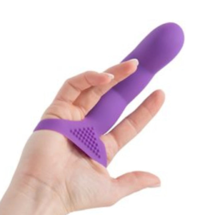 The Simple and True Silicone G-Spot Finger Extender - Purple by BMS Enterprises is being held by a hand, designed specifically for g-spot stimulation. The device boasts a textured triangular base and an elongated, rounded end. The hand's index and middle fingers are slotted through loops on the base, allowing for easy handling and precise control.