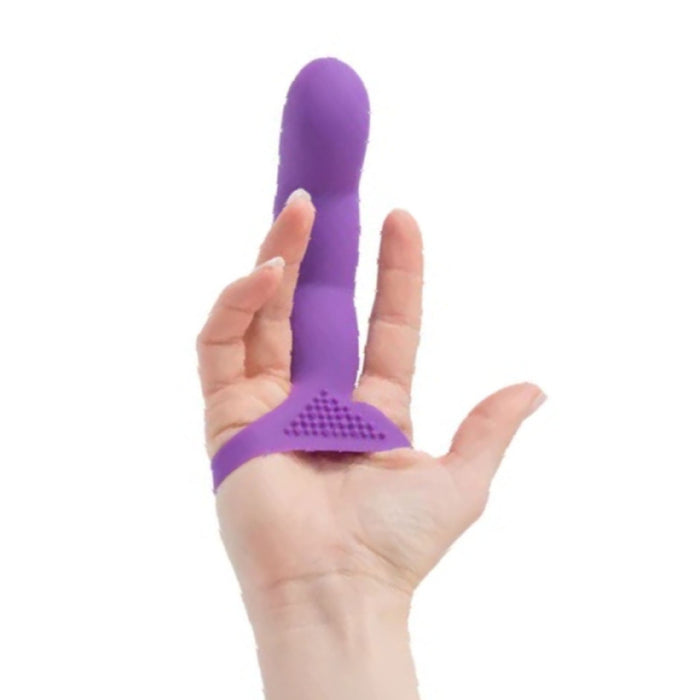 A hand holding the Simple and True Silicone G-Spot Finger Extender - Purple by BMS Enterprises. The toy, designed to be worn on the finger, features a bulbous, ribbed tip made of soft silicone for a stimulating texture. It also has a textured triangular base for added stimulation.