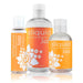 Three bottles of Sliquid Sizzle Natural Stimulating Lubricant, a vegan-friendly and water-based personal lubricant from Sliquid, in various sizes. The labels feature an orange background with white floral design elements. The arrangement has the largest bottle in the back, while two smaller bottles are positioned in front.