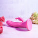 The Somebunny to Love Uncut Look Rabbit Vibrator by Evolved Novelties, a waterproof, pink silicone vibrator with dual stimulation points and a suction base, is displayed on a light-colored surface. The uncut rabbit vibrator is surrounded by pink roses on the left and white hydrangeas on the right, set against a subtle, pastel background.