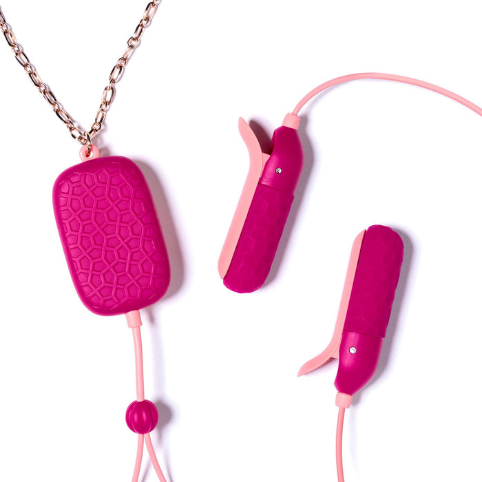 The Sphinx Bluetooth App-controlled Vibrating Nipple Clamps feature pink, textured, body-safe silicone clamps connected by cords. The wearable main unit hangs from a gold chain and seamlessly integrates with the OhMiBod Remote App. Set against a white background for a sleek design.