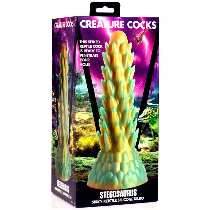 The image reveals the packaging of a product called "Stegosaurus Spiky Reptile Silicone Dildo" by XR Brands. The packaging showcases a spiky silicone sex toy against a vibrant, fantasy-themed background with lightning and dinosaurs.