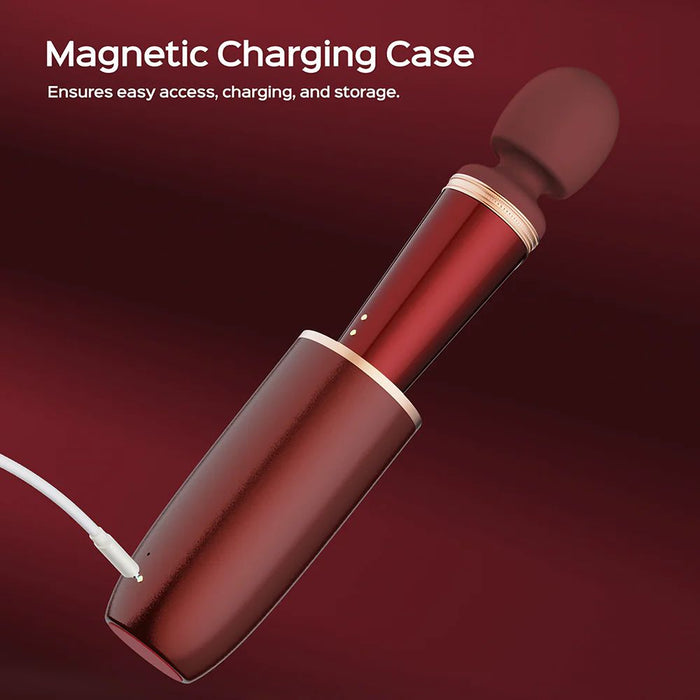 The Honey Play Box Stormi Powerful Heating Wand Vibrator, featuring a red personal massager with a rounded head, is shown partially inserted in its corresponding magnetic charging case. A charging cable connects to the sleek case, set against a gradient of red hues. Text at the top states, "Magnetic Charging Case - Ensures easy access, charging, and storage." This product offers multiple vibration patterns for an enhanced experience.