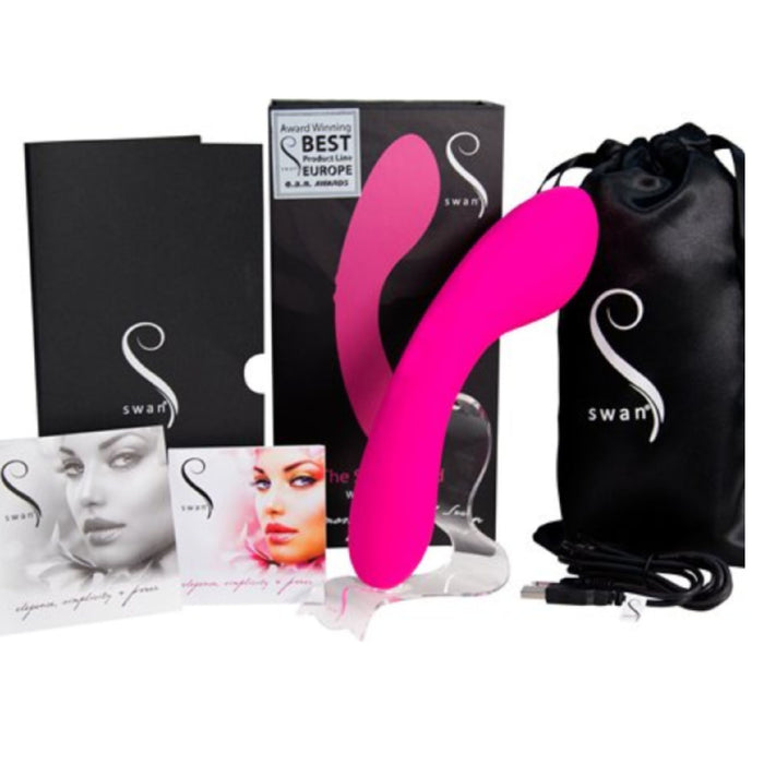 Displayed alongside its packaging is the Swan Wand Powerful Rumbly Double Ended 2 Motor Vibrator from BMS Enterprises, a pink, S-shaped personal massager made from 100% silicone. The set includes a black drawstring storage bag, a USB charging cable, and promotional material. The box proudly features an award for Best Product in Europe. The "Swan" brand logo is clearly visible on all items.