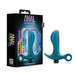 The image showcases the blue Teleportation Vibrating Silicone Prostate Massager & Butt Plug from Blush, featuring a T-shaped handle and loop for enhanced anal pleasure. It is positioned next to its elegant black packaging box, which is labeled "ANAL Adventures Matrix" and adorned with colorful geometric patterns and a holographic design.