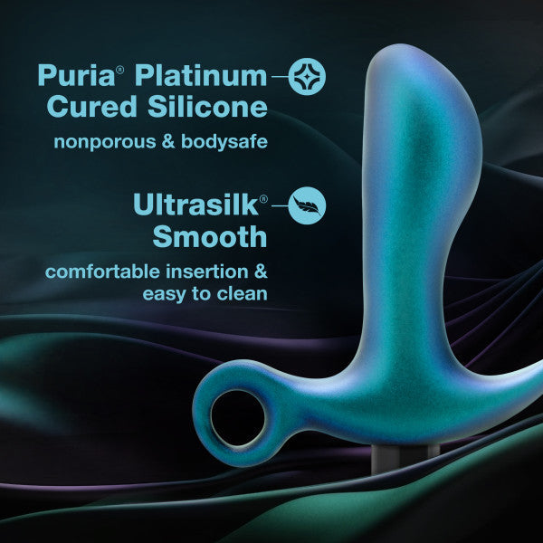 Against a dark wavy background, the Teleportation Vibrating Silicone Prostate Massager & Butt Plug by Blush is showcased. Text highlights its features: made with Puria platinum-cured silicone, ensuring it's nonporous and bodysafe, as well as Ultrasilk smooth for comfortable insertion and easy cleaning.