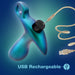 A blue and green gradient, teardrop-shaped Teleportation Vibrating Silicone Prostate Massager & Butt Plug by Blush features a loop at the top and connects to a USB cable for charging. The background showcases a blue gradient with the text "USB Rechargeable" at the bottom.