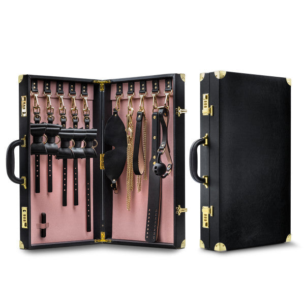 Two leather-bound cases from the Temptasia Safe Word Bondage Kit by Blush are shown. The left case is open, revealing various BDSM accessories including cuffs, collars, chains, paddles, and a gag—perfect for both beginners and intermediate players. The right case is closed, showcasing its exterior. Both have gold accents, handles, and lock mechanisms.