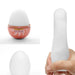 A collage showing three images of rounded objects: the top left shows a Tenga Egg Disposable Penis Masturbator - Cone from the Tenga EGG Series in a cup, the top right features a person holding a frosted glass bottle by its.