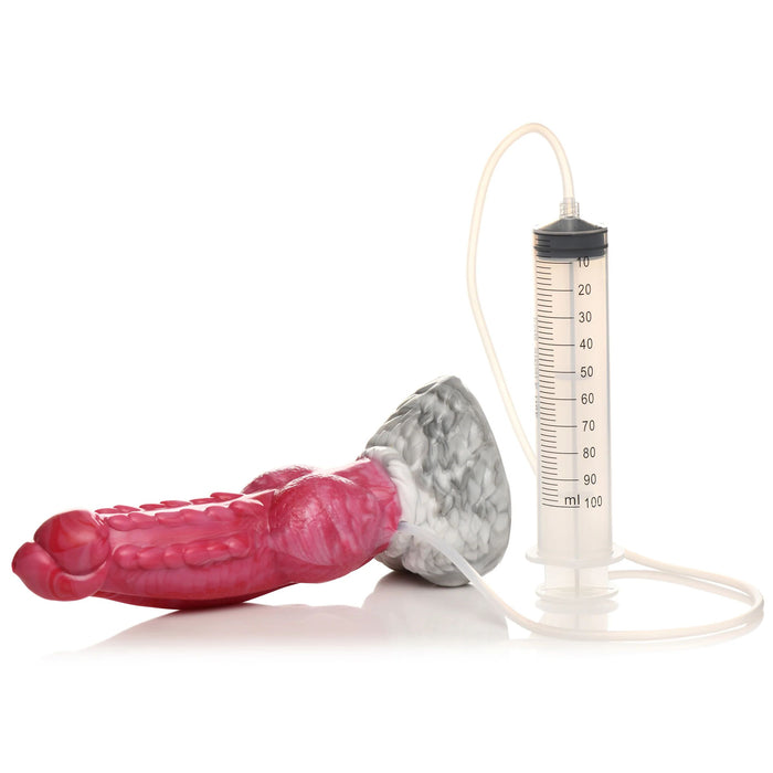 A vibrant medical-inspired device, The Phoenix Squirting 9 inch Silicone Fantasy Dildo by XR Brands, is designed in a bulbous shape with a gradient of pink and gray. It features a thin tube connecting to a transparent syringe marked with measurement lines, with the plunger partially extended, prepared for squirting fluids.