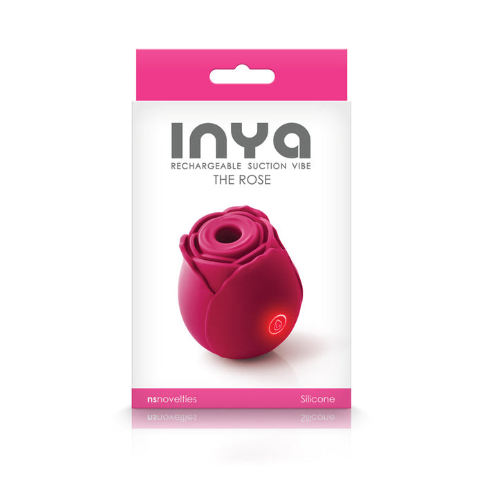 Packaging image of The Rose Powerful Clitoral Air Pulsation Vibrator, a pink, rose-shaped silicone rechargeable suction vibe by NS Novelties, showcasing its innovative air pulsation for clitoral stimulation through a clear window on the front. The box is primarily white and pink with text indicating the brand and product details.