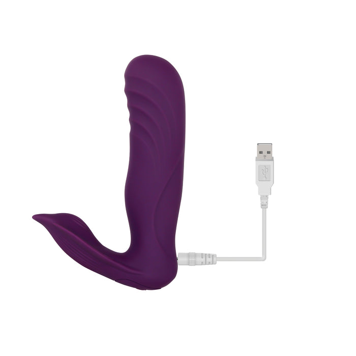 The Velvet Hammer Thrusting Hands-Free Dual Stimulation Vibrator by Evolved Novelties is a purple handheld personal massager with a curved design, made from waterproof silicone for ultimate comfort. It comes with a USB charging cable and operates as a wireless remote-controlled vibrator, all set against a plain white background.