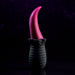 A modern, sculptural object featuring a geometric black base and a tall, red curved top resembling the Tongue Teaser Flickering Realistic Red Tongue Vibrator by Evolved Novelties. The background is dark with hints of purple, giving a dramatic and artistic look to the image.