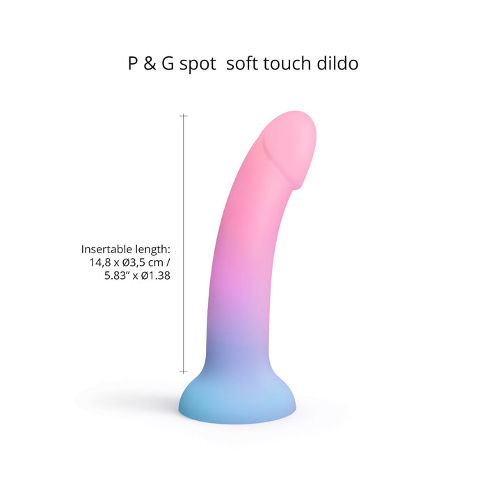 A gradient-colored dildo featuring shades of pink and blue is displayed. The text reads, "Utopia Pink and Blue Ombre Silicone Dildo by Lovely Planet." With an insertable length of 14.8 cm x Ø3.5 cm / 5.83” x Ø1.38", this ergonomically curved shape dildo boasts a rounded head and a flared base—ideal for pegging.