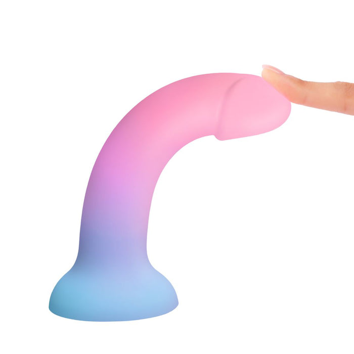 Dildolls Utopia Glow in the Dark Silicone Dildo being bent by model's finger 