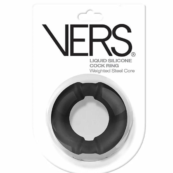 A black VERS Silicone Cock Ring with Weighted Steel Interior - Black is displayed in a clear plastic package. The package showcases "Vers®" at the top and "VERS Silicone Cock Ring with Weighted Steel Interior - Black" below it, designed to enhance sexual performance.