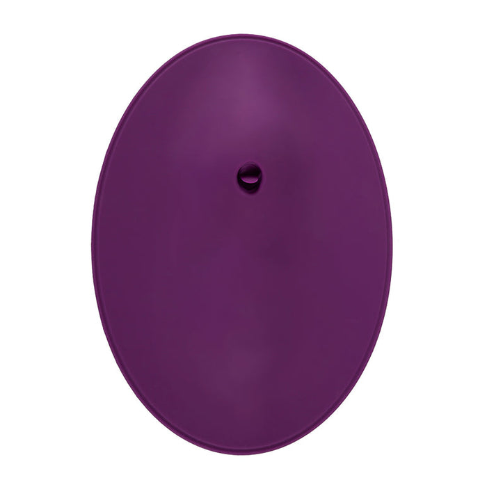 **VibePad 2 Ride On Hands-Free Humping Vibrator with Licking Tongue by Orion:** A sleek, purple silicone device featuring an oval shape and a small circular control in the center. The exterior is smooth with a consistent color, highlighting its simple yet highly functional and waterproof design—perfect for hands-free use.