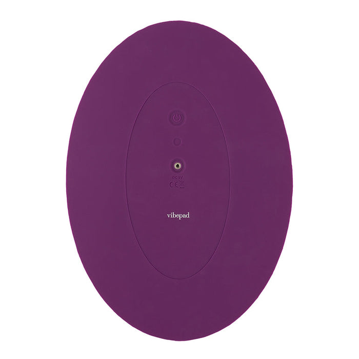 The VibePad 2 Ride On Hands-Free Humping Vibrator with Licking Tongue from Orion, features a minimalist design in purple with an oval shape, a central power button, an LED indicator light, and the logo "vibepad" beneath them. It boasts a waterproof construction and a smooth surface that is perfect for versatile use.