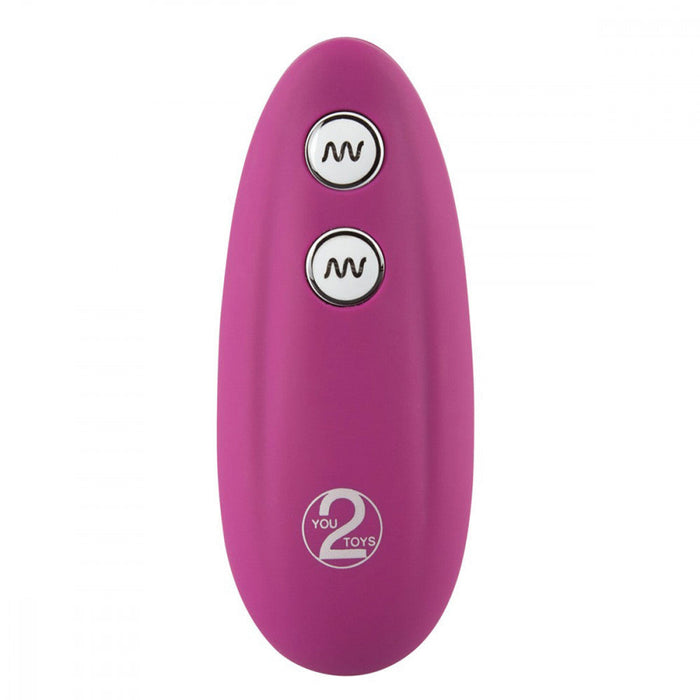 An oval-shaped electronic device in pink with two circular buttons featuring wavy line symbols on the front. The bottom of the device sports a logo inscribed with "YOU 2 TOYS." This waterproof gadget, known as the VibePad Ride On Hands-Free Humping Vibrator by Orion, appears to be designed for hands-free external stimulation.