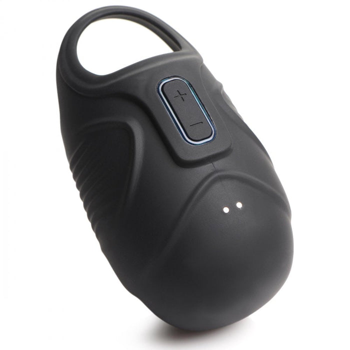 The Vibrating Silicone Waterproof Ball Sack by XR Brands is a black, portable device with an oval shape. It features a handle at the top for easy carrying, volume control buttons (+ and -) on the front, and two small LED indicator lights below the buttons. The surface is smooth with some textured grips.