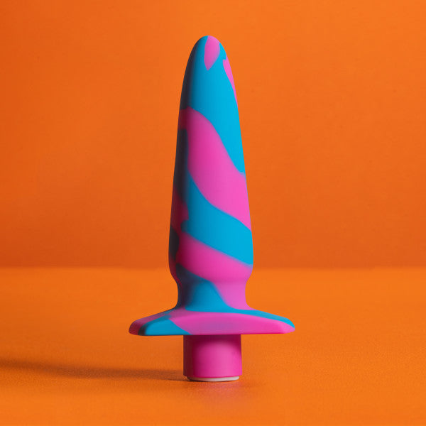 The Vibrotize 10 Function Vibrating Silicone Butt Plug by Blush, crafted from body-safe silicone and adorned with a vibrant blue and pink camouflage pattern, stands upright against an orange background. Its flared base ensures safe use, making it an excellent choice for anal experts.