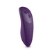 A We-Vibe Chorus Remote & App Controlled Couples' Vibrator in purple, featuring a curved body and several touch-sensitive control buttons, including a plus sign, minus sign, and circular symbols. The device stands upright against a plain white background.